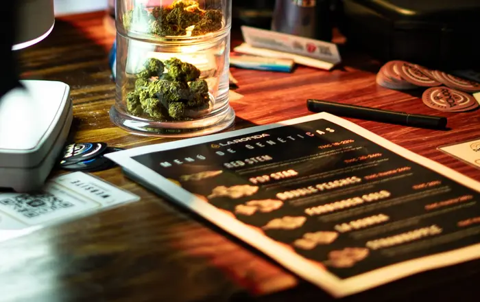Cannabis flower displayed in a jar on the counter of a licensed dispensary