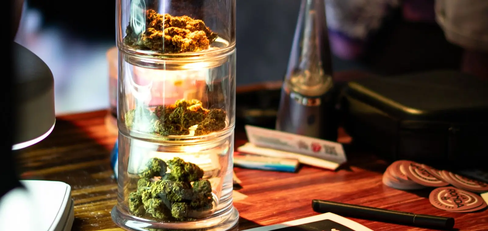 Cannabis flower displayed in a jar on the counter of a licensed dispensary