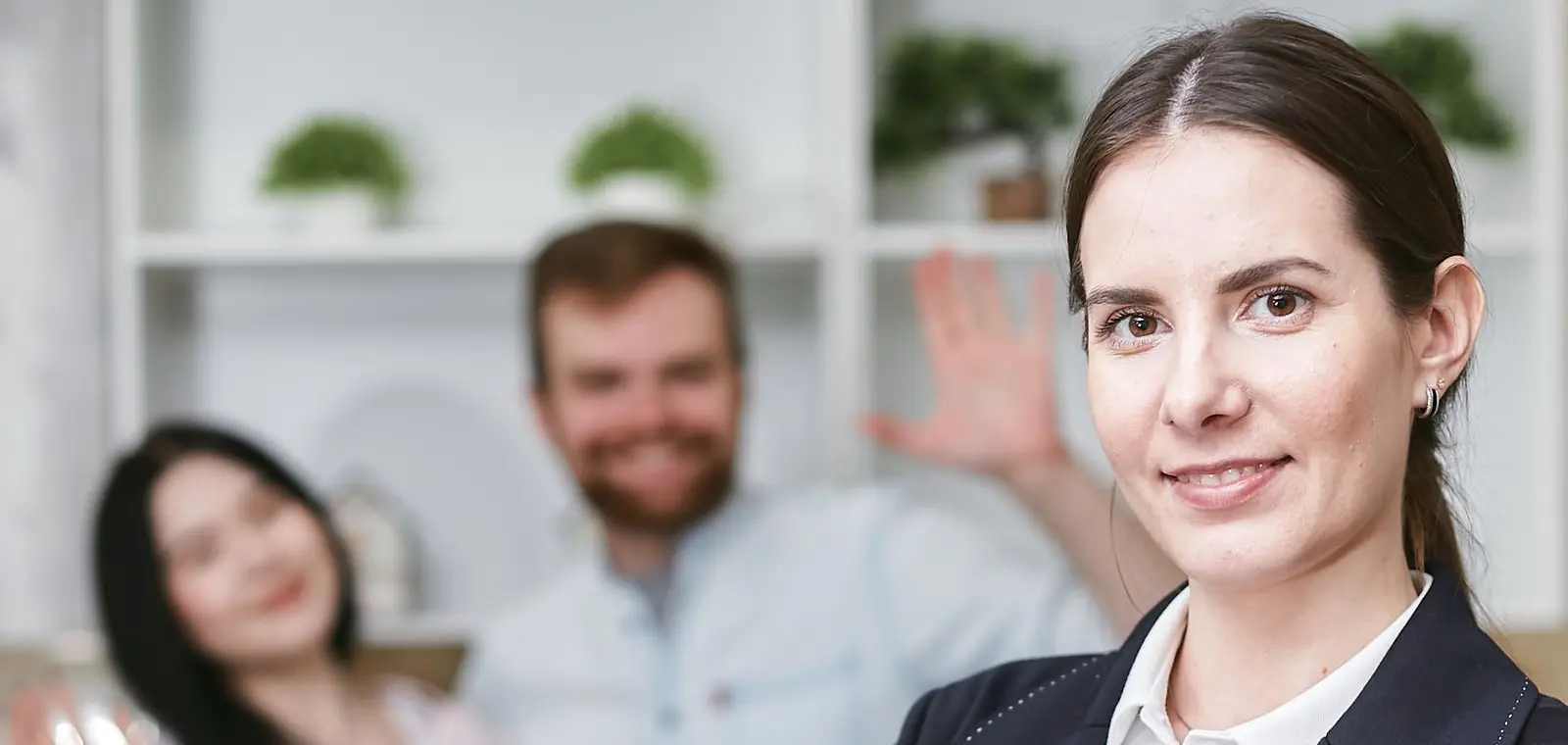 An insurance agent holding a home-insurance policy while meeting a family